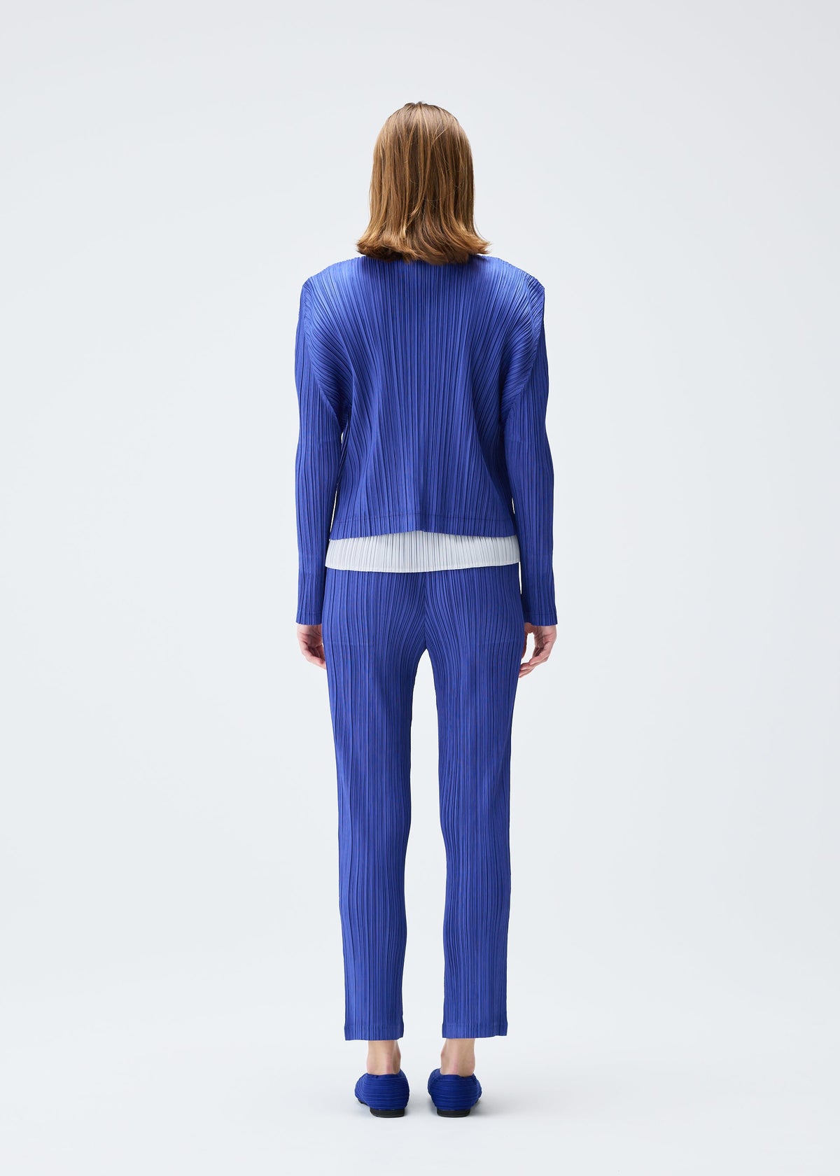 A model wears the PLEATS PLEASE ISSEY MIYAKE PLEATS JACKET jacket.