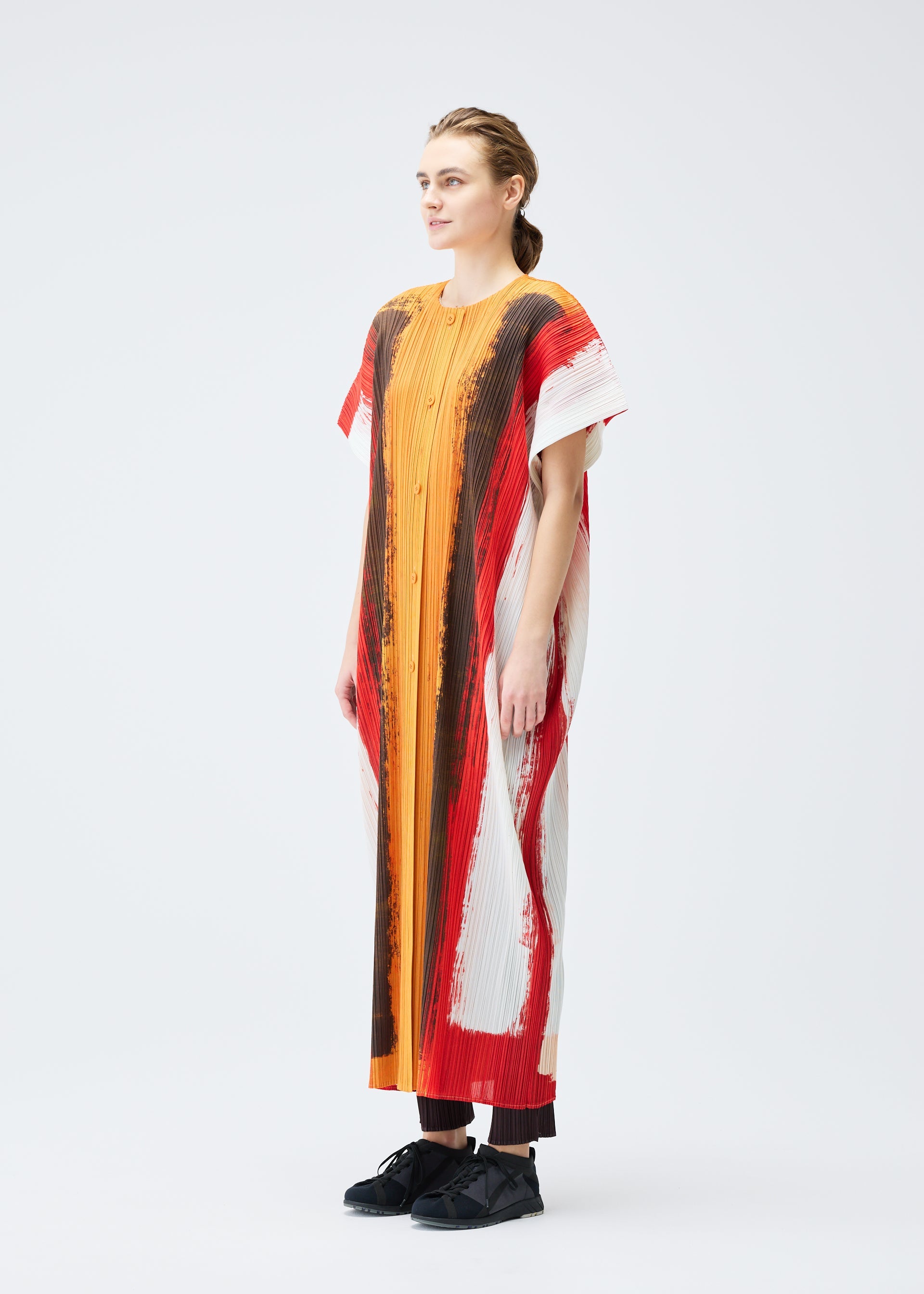 A model wears the PLEATS PLEASE ISSEY MIYAKE JUMP vest.