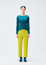 A model wears the PLEATS PLEASE ISSEY MIYAKE MONTHLY COLORS OCTOBER trousers.
