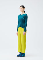 A model wears the PLEATS PLEASE ISSEY MIYAKE MONTHLY COLORS OCTOBER trousers.