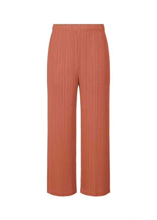A product shot of the PLEATS PLEASE ISSEY MIYAKE MONTHLY COLORS OCTOBER trousers in coral pink (29).