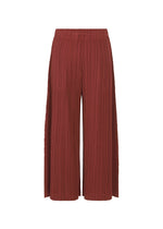 A detail shot of the PLEATS PLEASE ISSEY MIYAKE WOOL PLEATS trousers.