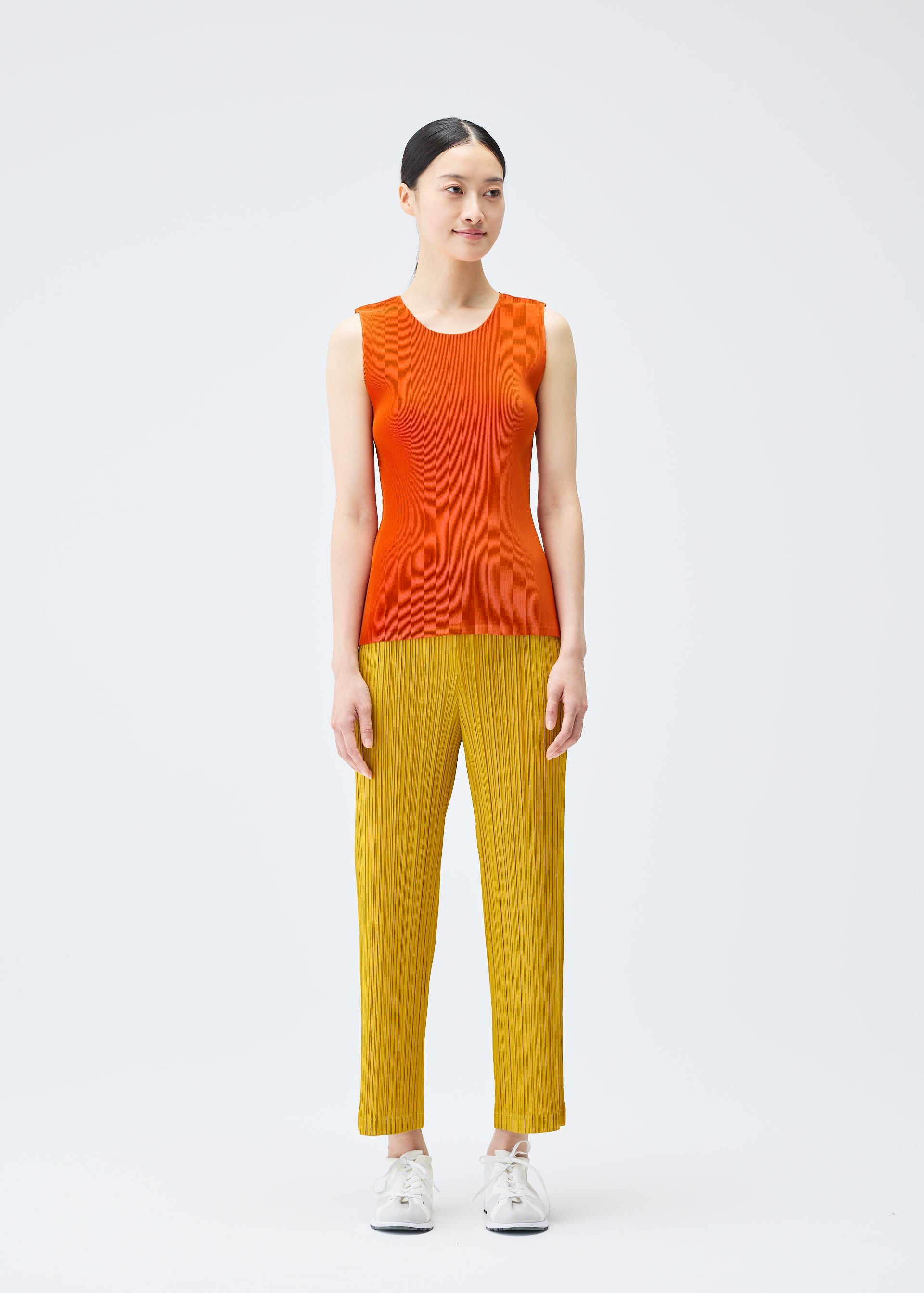 A model wears the PLEATS PLEASE ISSEY MIYAKE THICKER BOTTOMS 1 trousers.