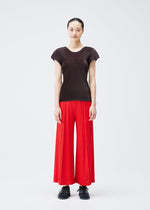 A model wears the PLEATS PLEASE ISSEY MIYAKE THICKER BOTTOMS 1 trousers.