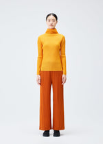 A model wears the PLEATS PLEASE ISSEY MIYAKE LOOP BOTTOMS clothing.