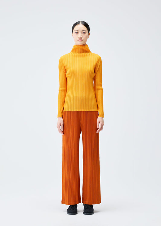A model wears the PLEATS PLEASE ISSEY MIYAKE LOOP BOTTOMS clothing.