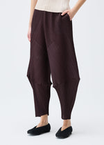 A model wears the PLEATS PLEASE ISSEY MIYAKE LEAP trousers.