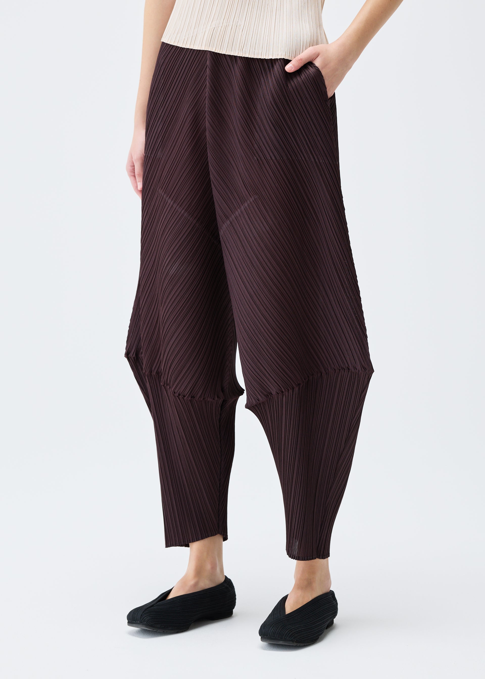 A model wears the PLEATS PLEASE ISSEY MIYAKE LEAP trousers.