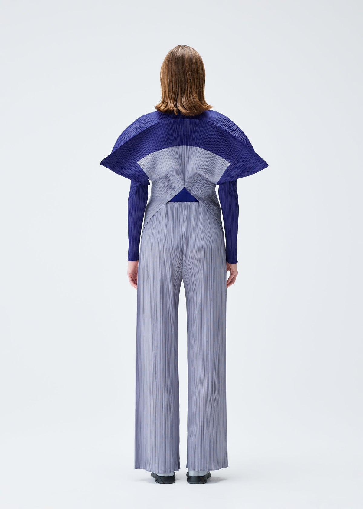 A model wears the PLEATS PLEASE ISSEY MIYAKE SQUARE trousers.