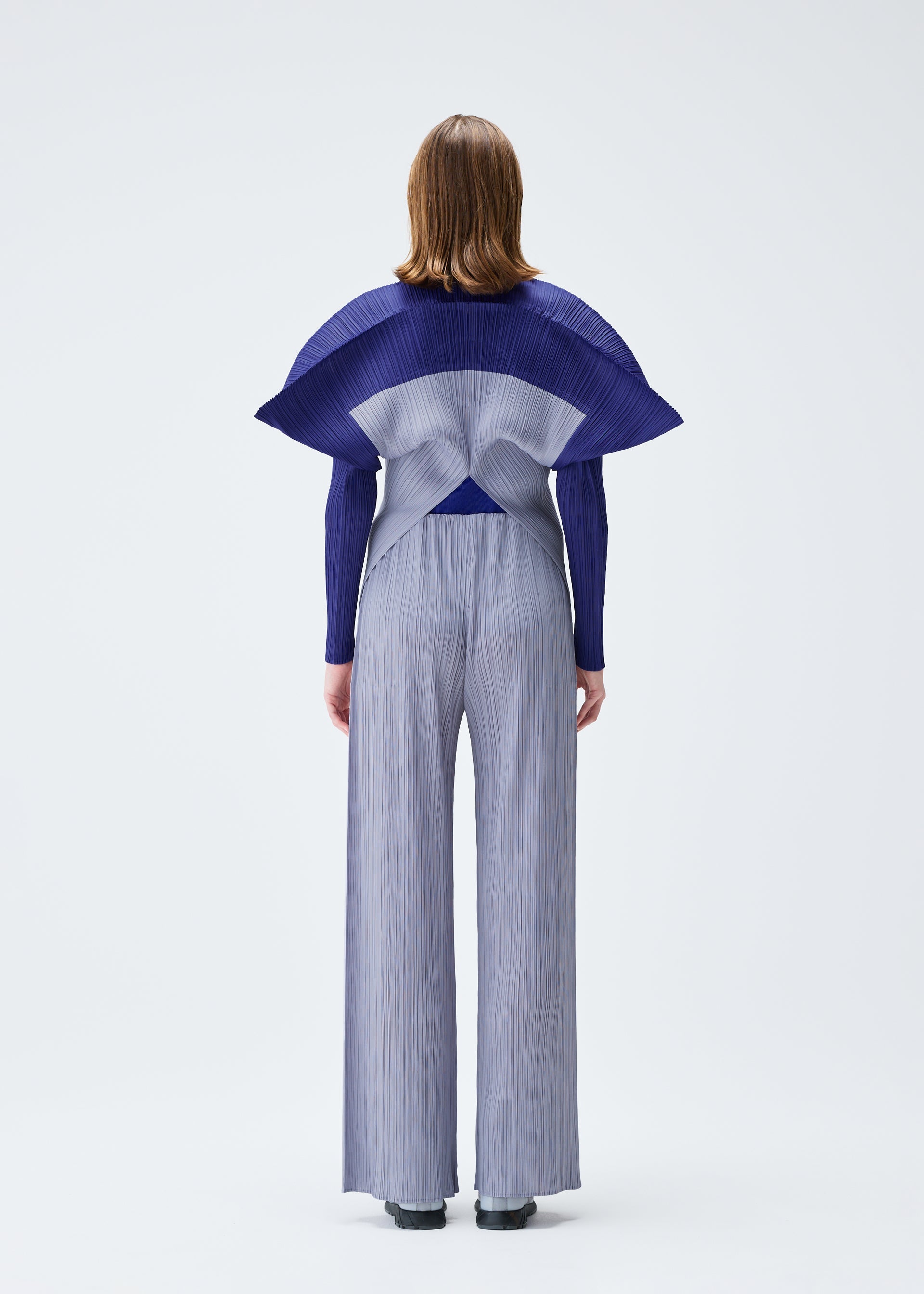 A model wears the PLEATS PLEASE ISSEY MIYAKE SQUARE trousers.