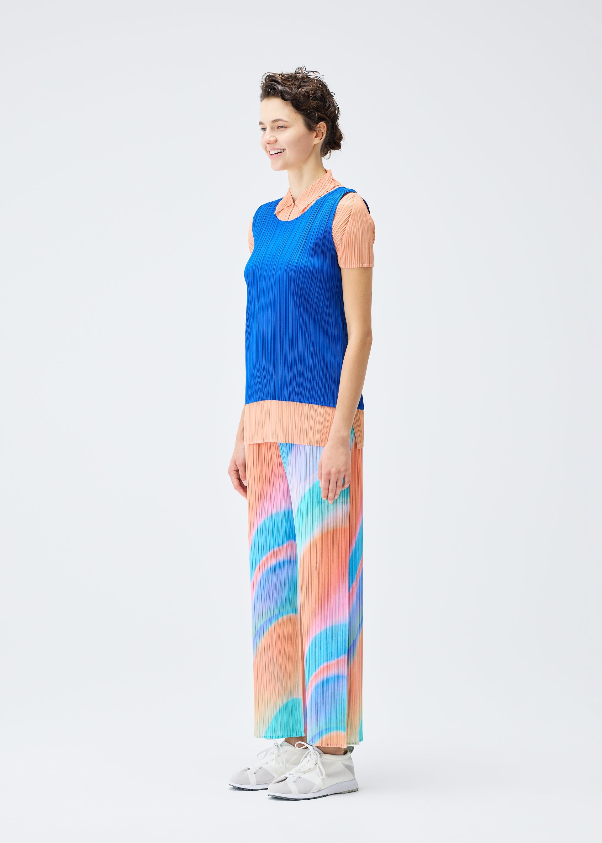 A model wears the PLEATS PLEASE ISSEY MIYAKE GROOVE trousers.