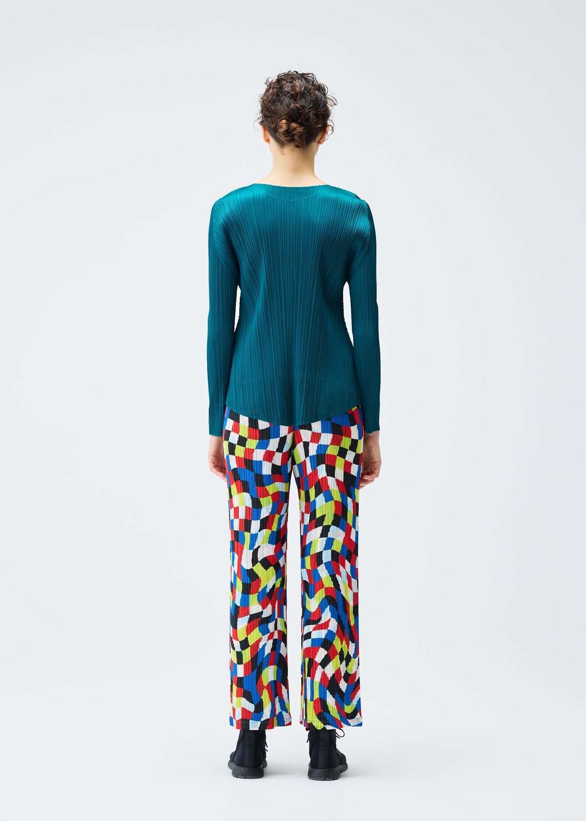 A model wears the PLEATS PLEASE ISSEY MIYAKE DANCING SQUARE trousers.