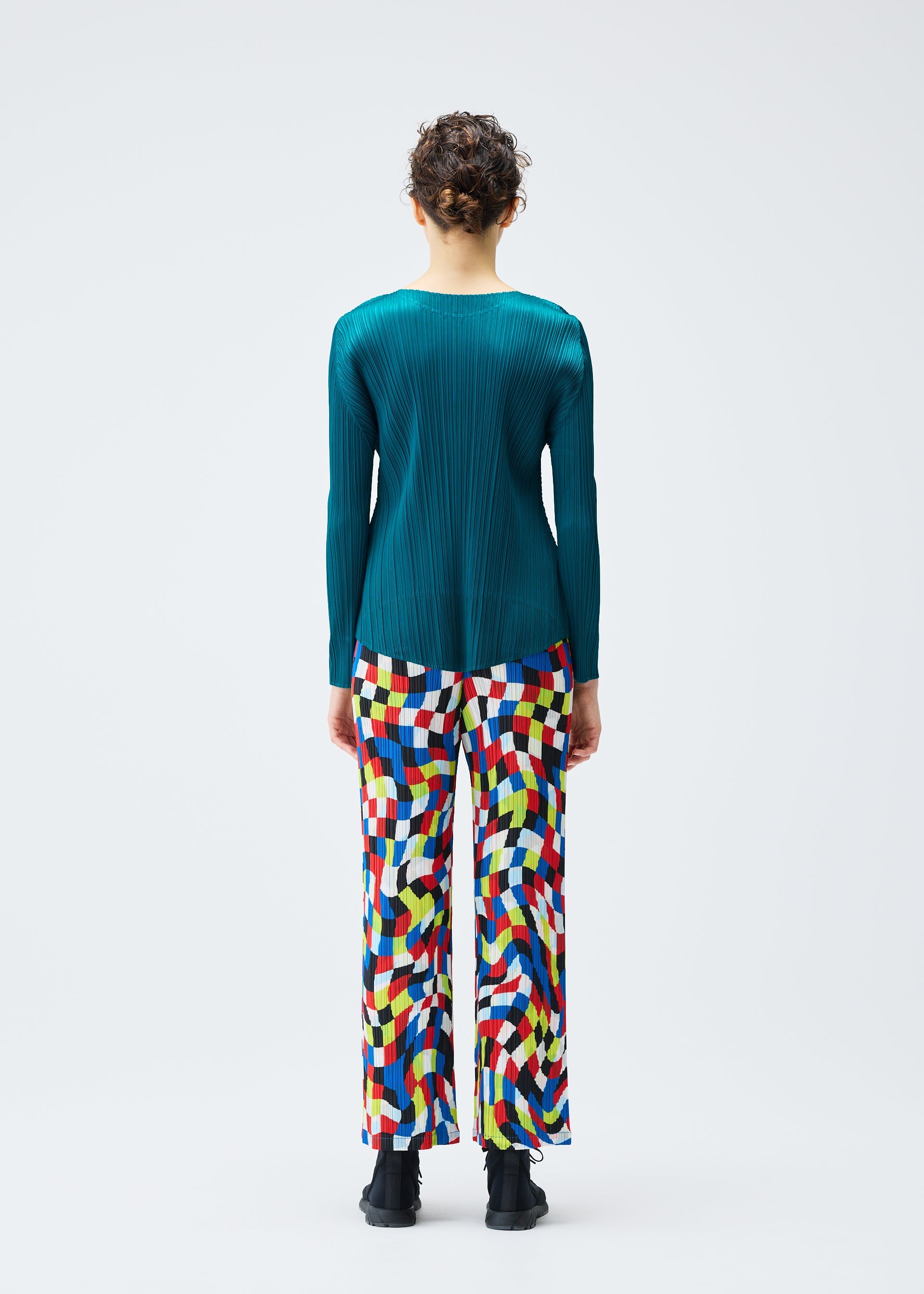 A model wears the PLEATS PLEASE ISSEY MIYAKE DANCING SQUARE trousers.