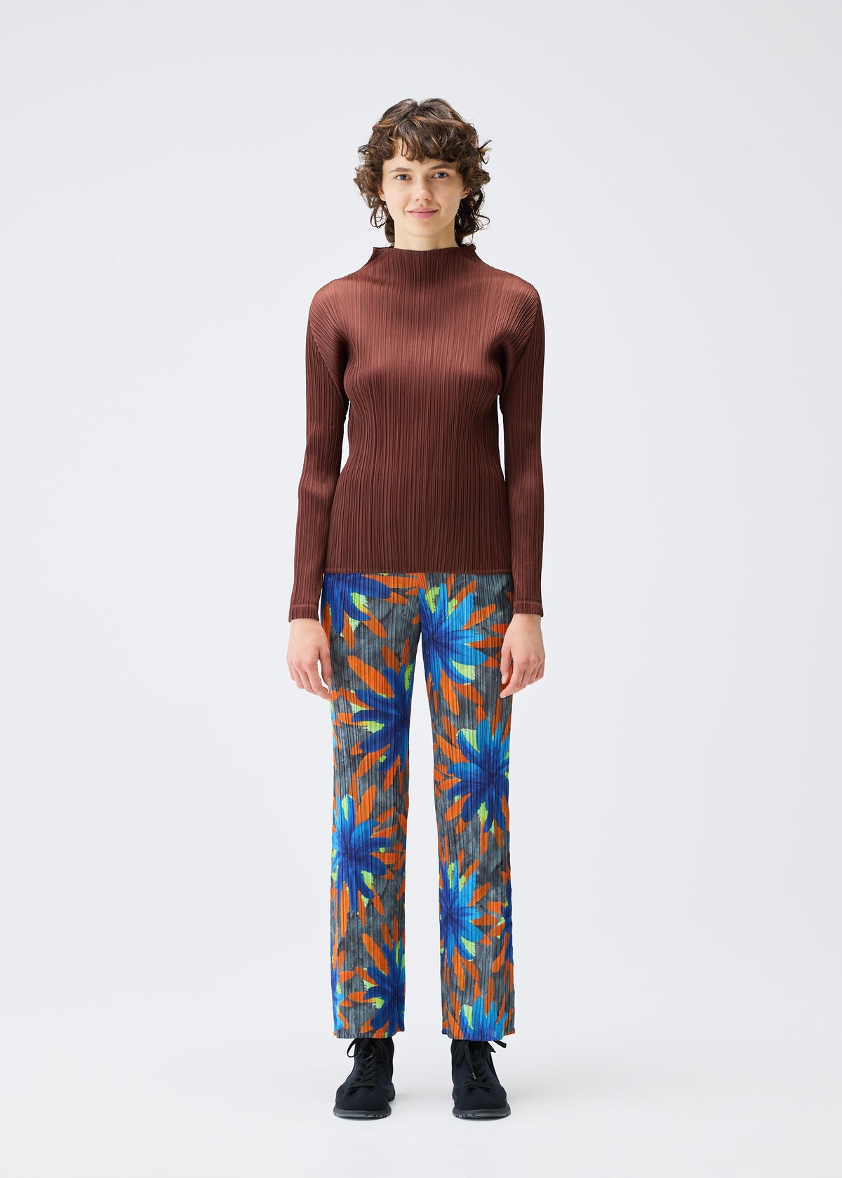 A model wears the PLEATS PLEASE ISSEY MIYAKE CARNIVAL trousers.