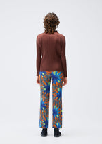 A model wears the PLEATS PLEASE ISSEY MIYAKE CARNIVAL trousers.