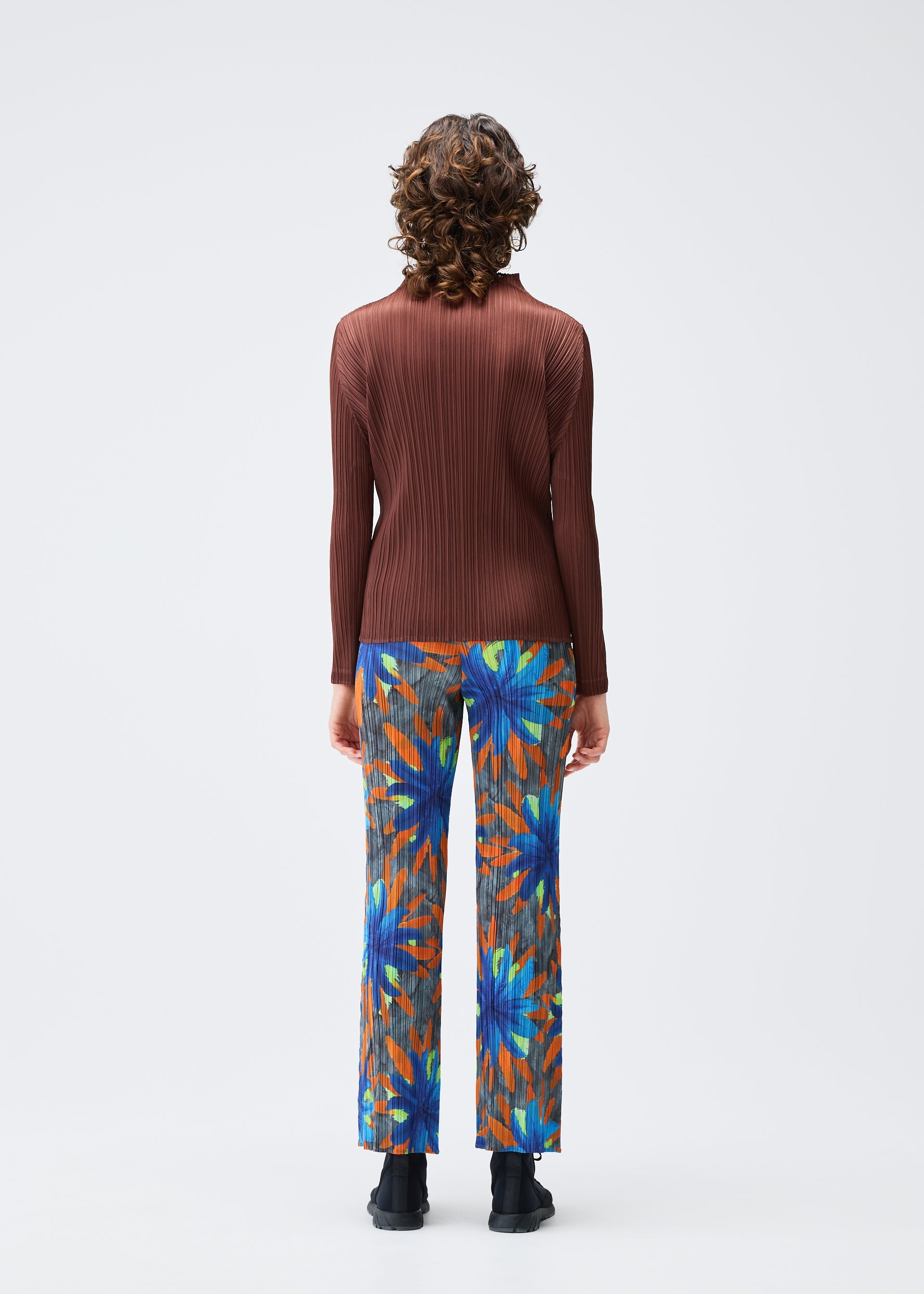 A model wears the PLEATS PLEASE ISSEY MIYAKE CARNIVAL trousers.