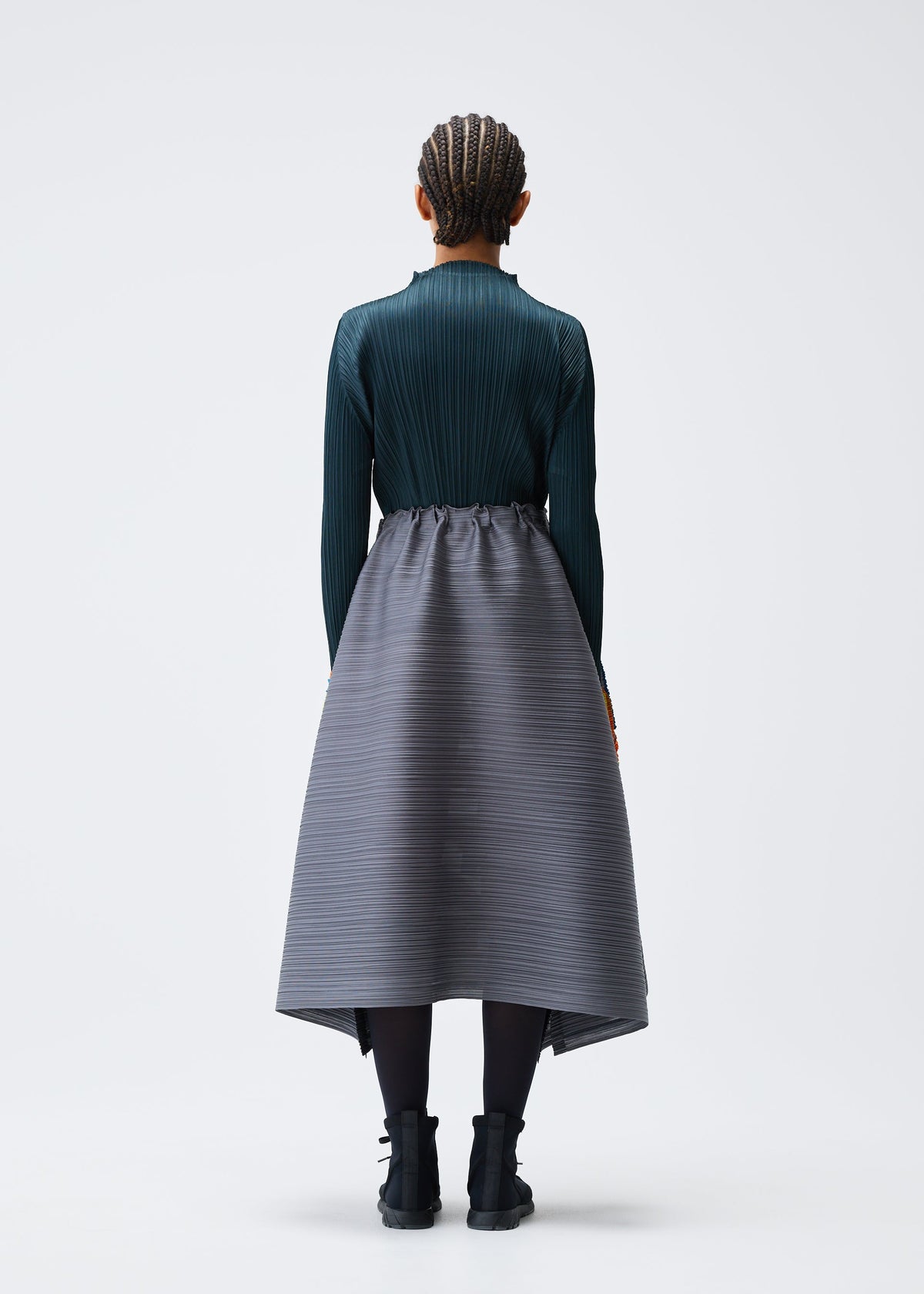 A model wears the PLEATS PLEASE ISSEY MIYAKE MIX skirt.