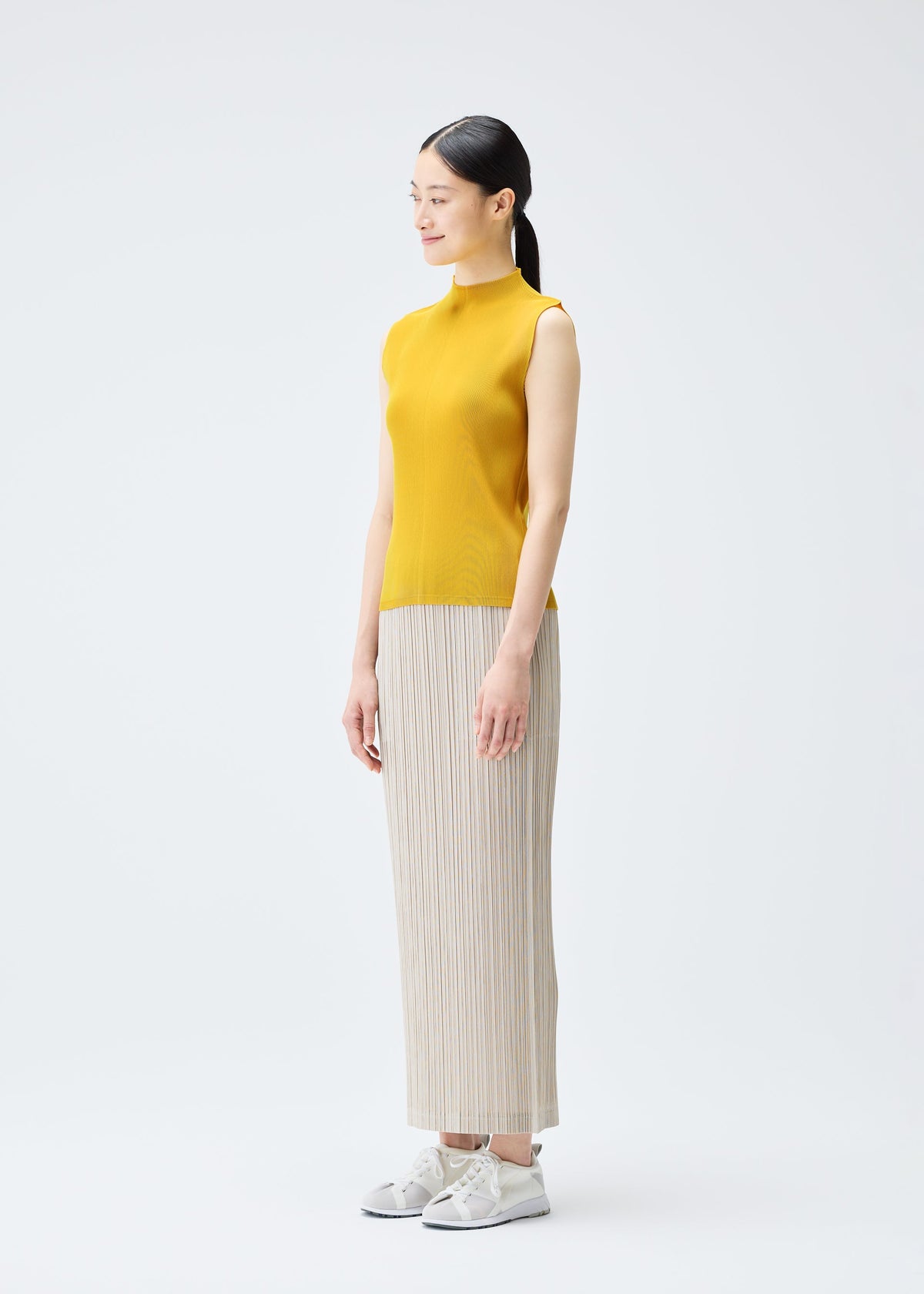 A model wears the PLEATS PLEASE ISSEY MIYAKE THICKER BOTTOMS 1 skirt.