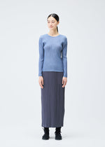 A model wears the PLEATS PLEASE ISSEY MIYAKE LOOP BOTTOMS clothing.