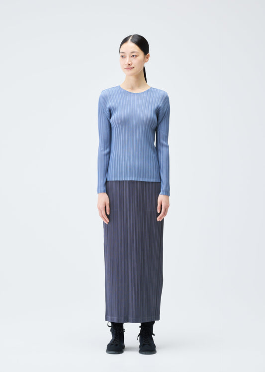 A model wears the PLEATS PLEASE ISSEY MIYAKE LOOP BOTTOMS clothing.