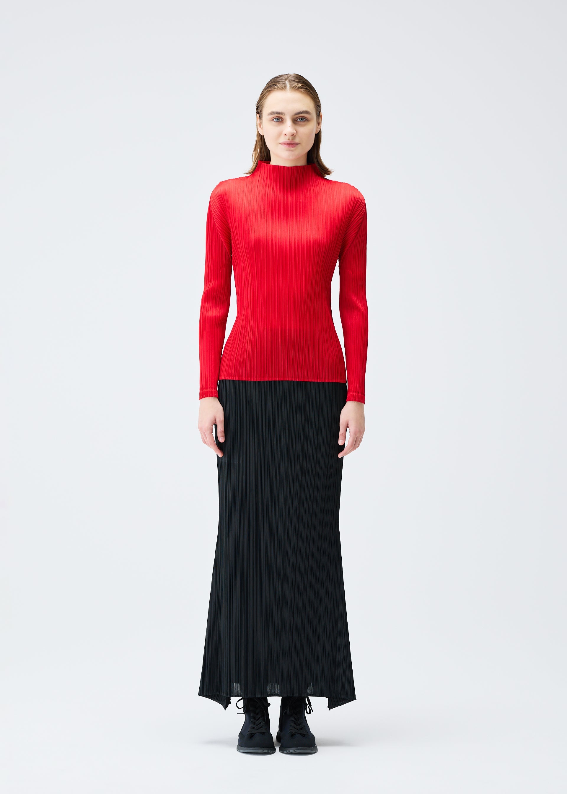 A model wears the PLEATS PLEASE ISSEY MIYAKE OLE! clothing.