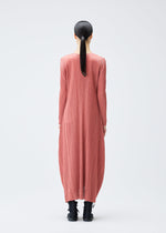 A model wears the PLEATS PLEASE ISSEY MIYAKE MONTHLY COLORS OCTOBER dress.