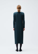 A model wears the PLEATS PLEASE ISSEY MIYAKE MONTHLY COLORS NOVEMBER dress.