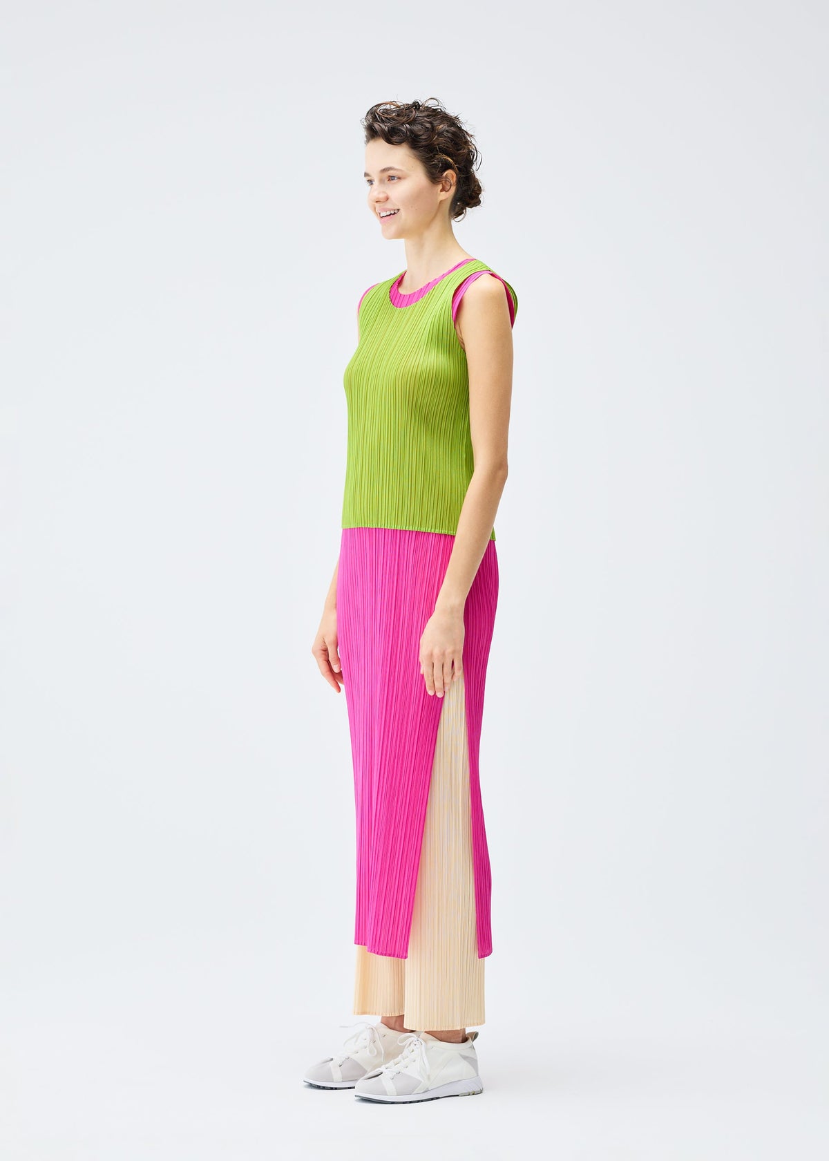 A model wears the PLEATS PLEASE ISSEY MIYAKE LUCID PLEATS dress.