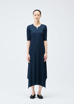 A model wears the PLEATS PLEASE ISSEY MIYAKE MELLOW PLEATS dress.