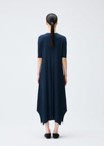 A model wears the PLEATS PLEASE ISSEY MIYAKE MELLOW PLEATS dress.