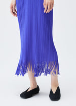 A model wears the PLEATS PLEASE ISSEY MIYAKE WAVE dress.