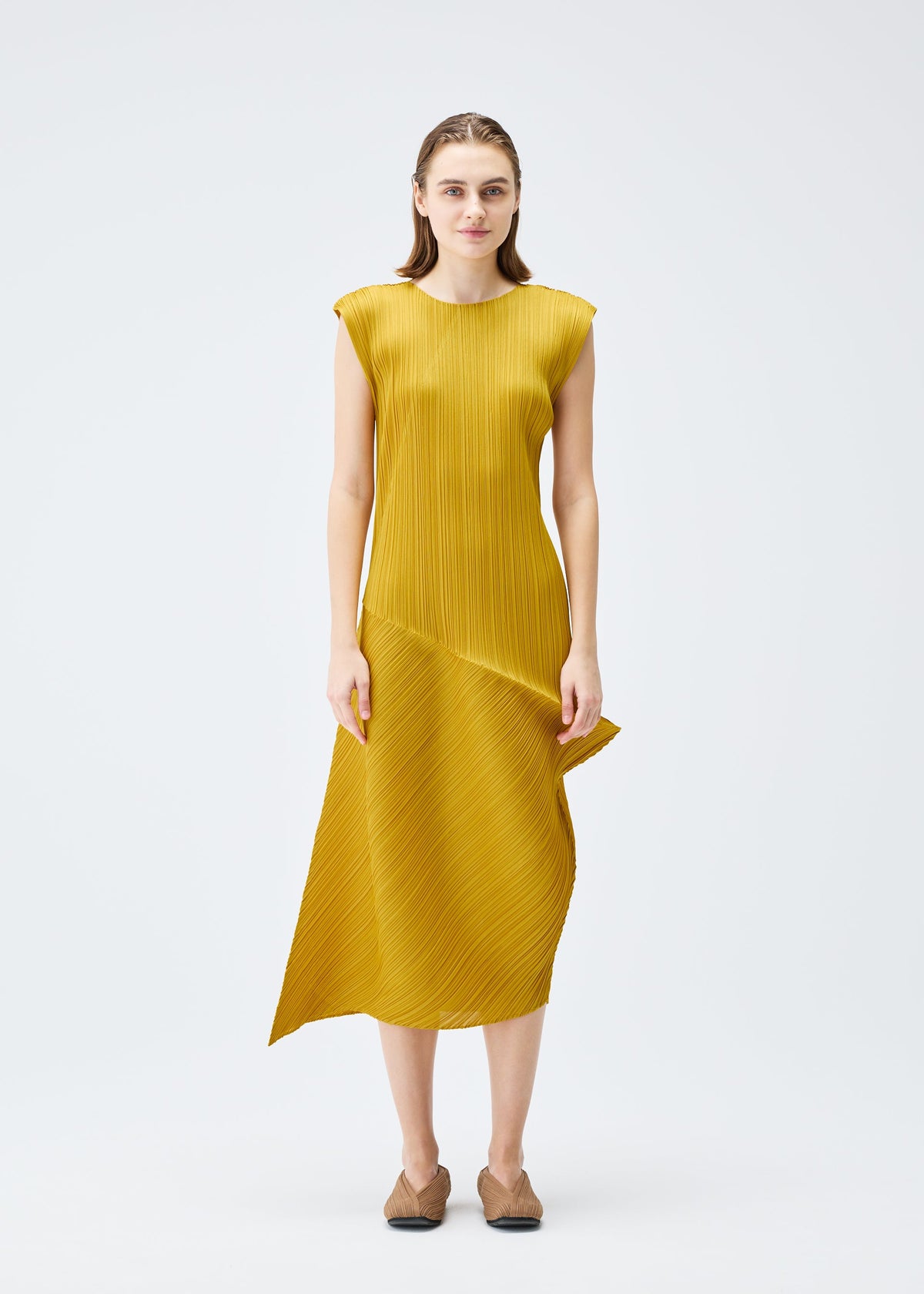 A model wears the PLEATS PLEASE ISSEY MIYAKE LEAP dress.