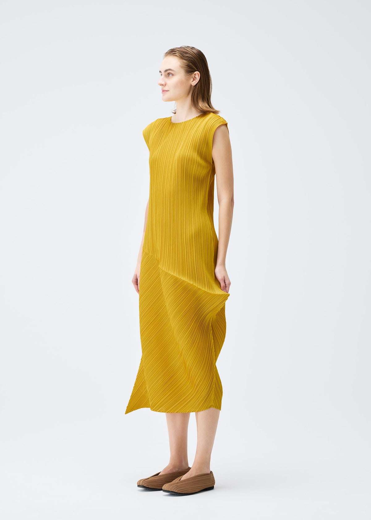 A model wears the PLEATS PLEASE ISSEY MIYAKE LEAP dress.