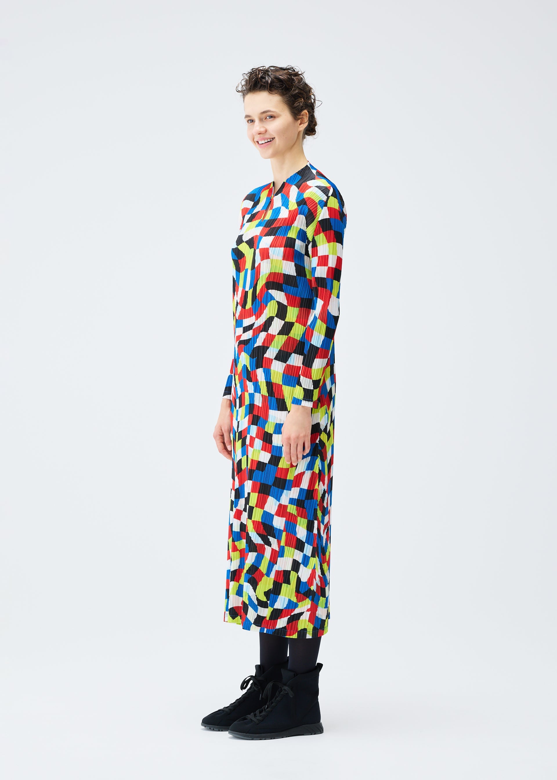 A model wears the PLEATS PLEASE ISSEY MIYAKE DANCING SQUARE dress.