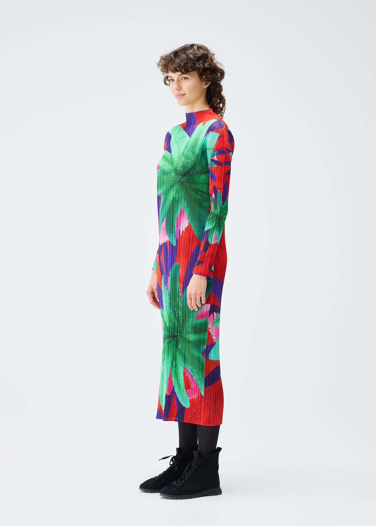 A model wears the PLEATS PLEASE ISSEY MIYAKE CARNIVAL dress.