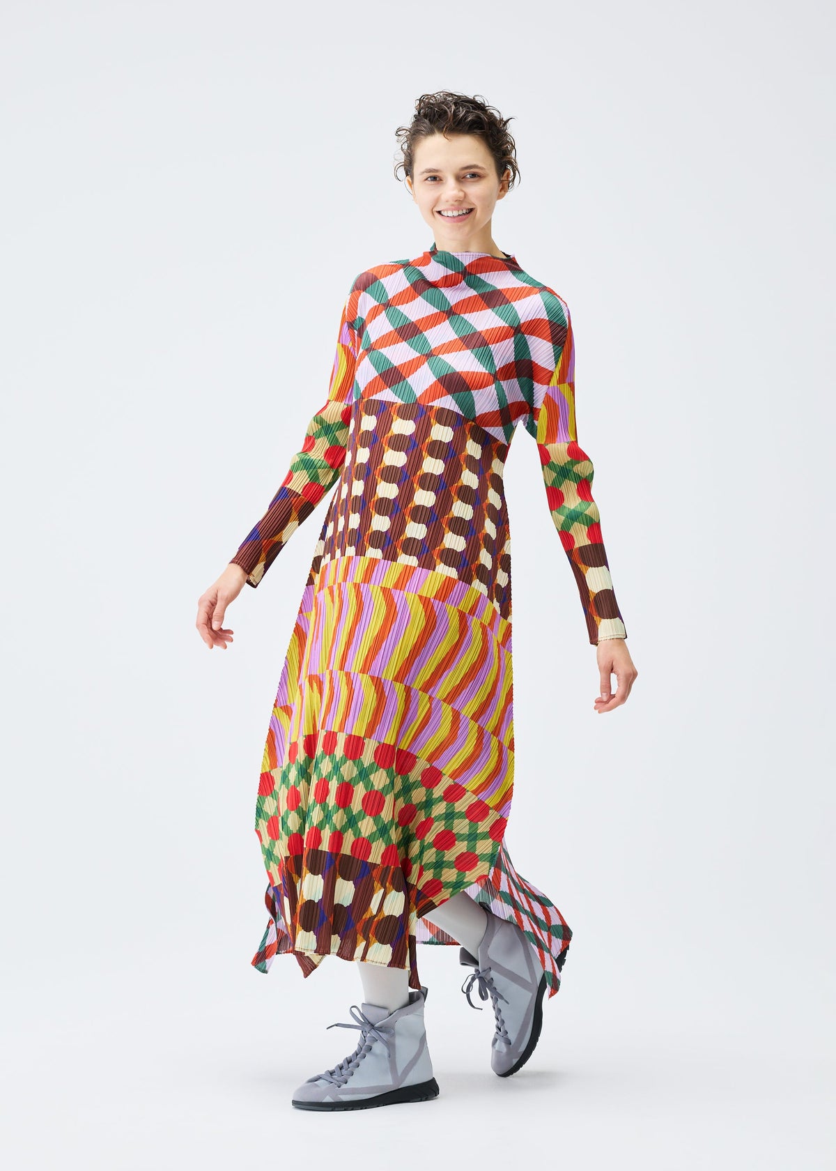 A model wears the PLEATS PLEASE ISSEY MIYAKE HARMONY clothing.