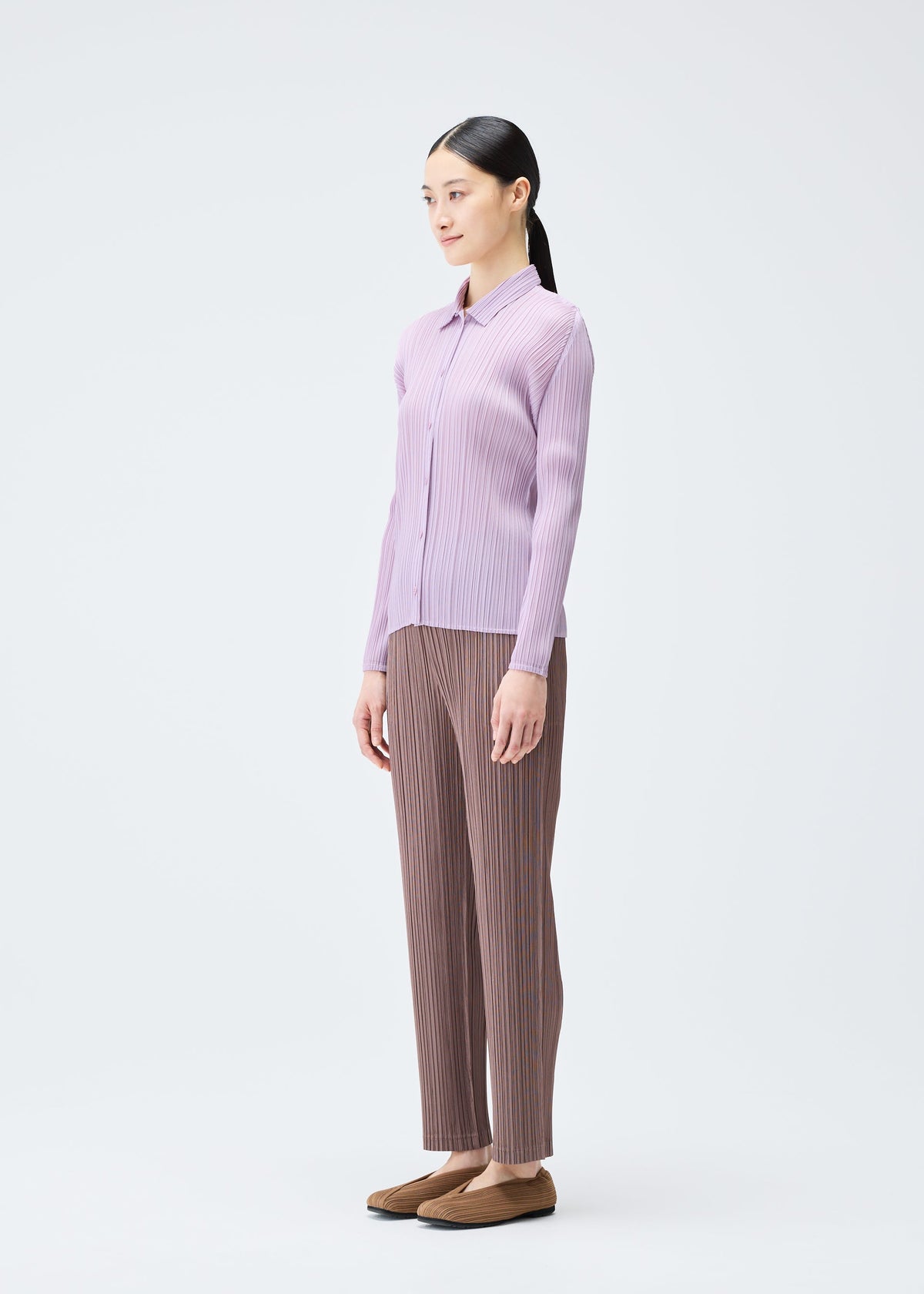 A model wears the PLEATS PLEASE ISSEY MIYAKE PLEATS SHIRT shirt.