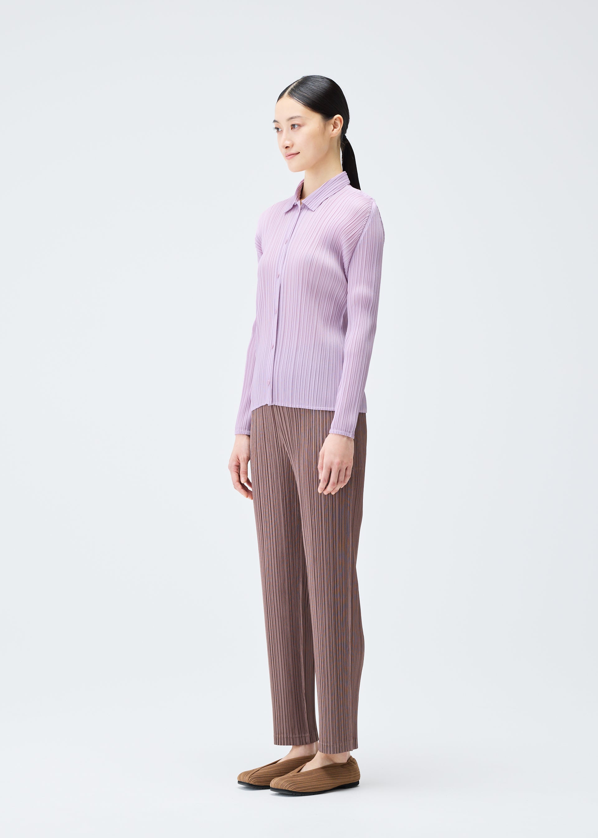 A model wears the PLEATS PLEASE ISSEY MIYAKE PLEATS SHIRT shirt.