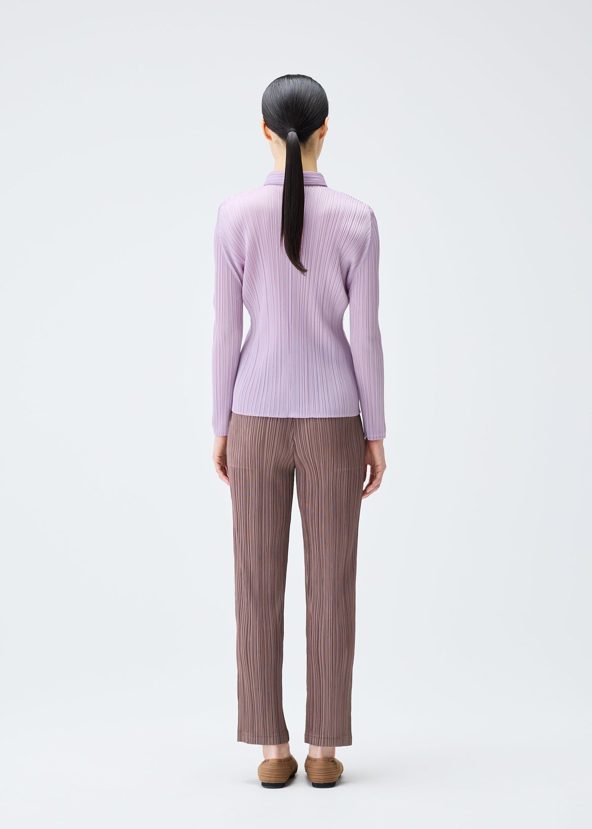 A model wears the PLEATS PLEASE ISSEY MIYAKE PLEATS SHIRT shirt.