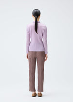 A model wears the PLEATS PLEASE ISSEY MIYAKE PLEATS SHIRT shirt.