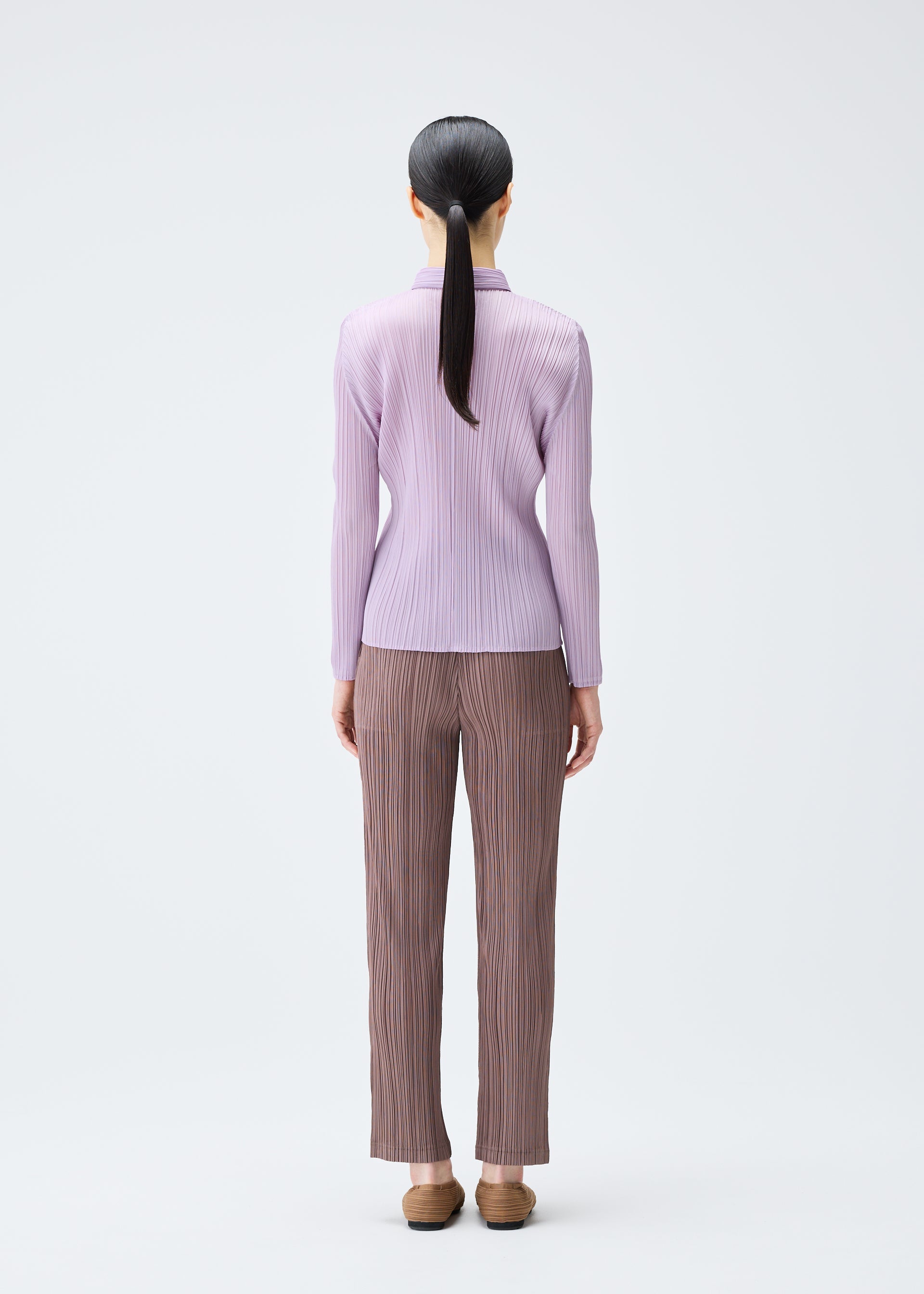 A model wears the PLEATS PLEASE ISSEY MIYAKE PLEATS SHIRT shirt.