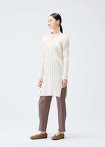 A model wears the PLEATS PLEASE ISSEY MIYAKE PLEATS SHIRT shirt.