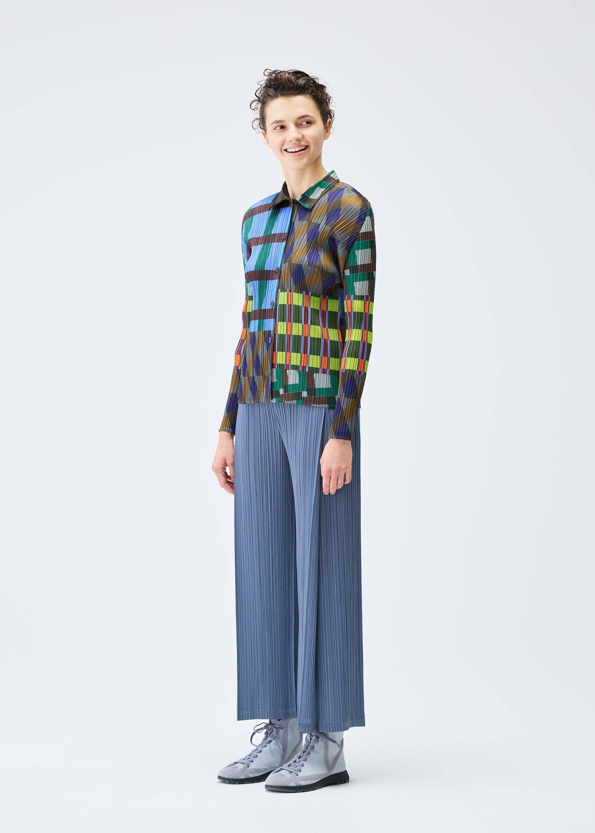 A model wears the PLEATS PLEASE ISSEY MIYAKE HARMONY clothing.