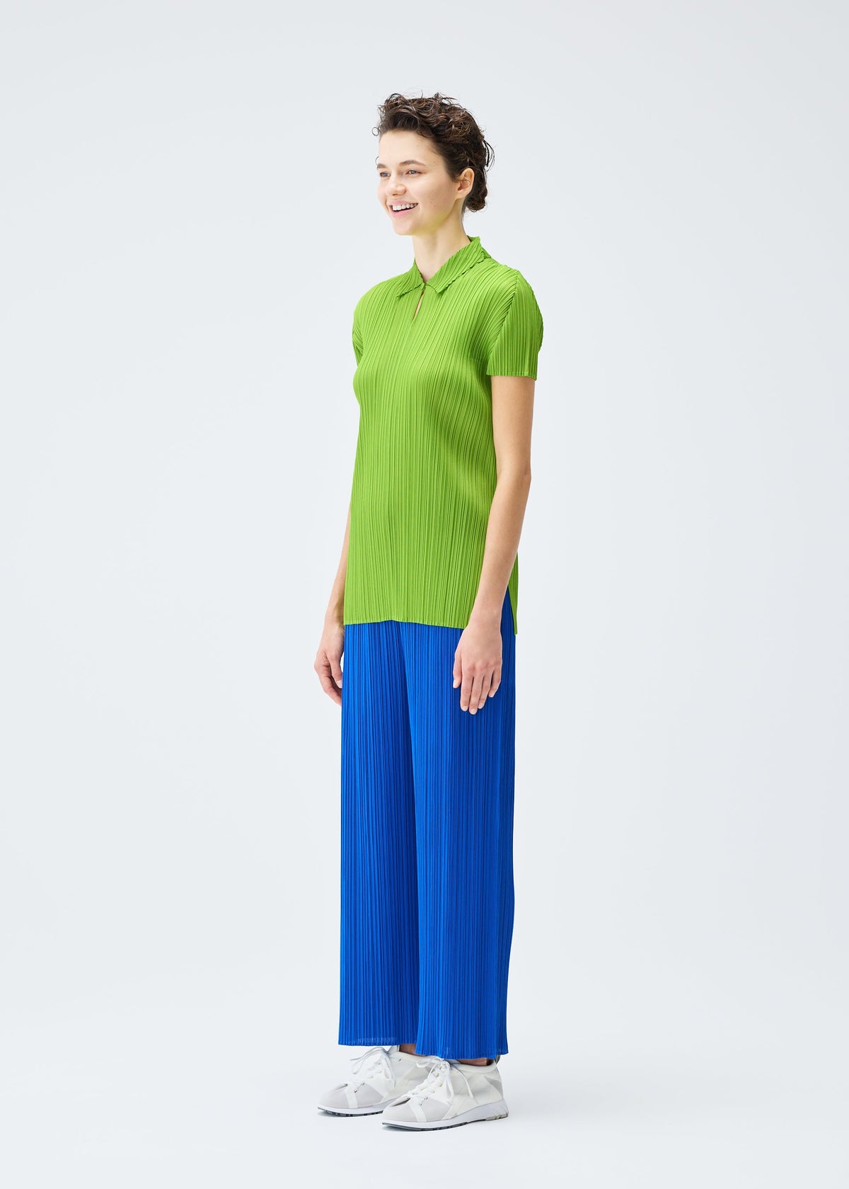 A model wears the PLEATS PLEASE ISSEY MIYAKE MONTHLY COLORS AUGUST top.