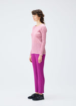 A model wears the PLEATS PLEASE ISSEY MIYAKE MONTHLY COLORS SEPTEMBER top.