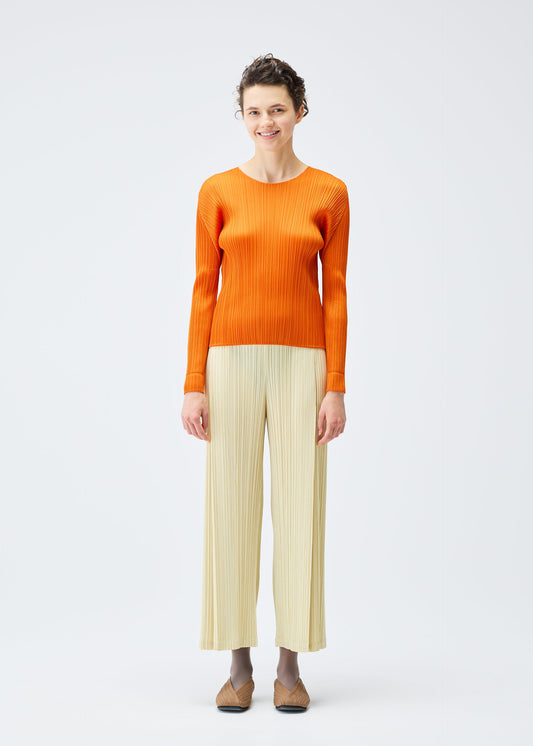 A model wears the PLEATS PLEASE ISSEY MIYAKE MONTHLY COLORS DECEMBER clothing.