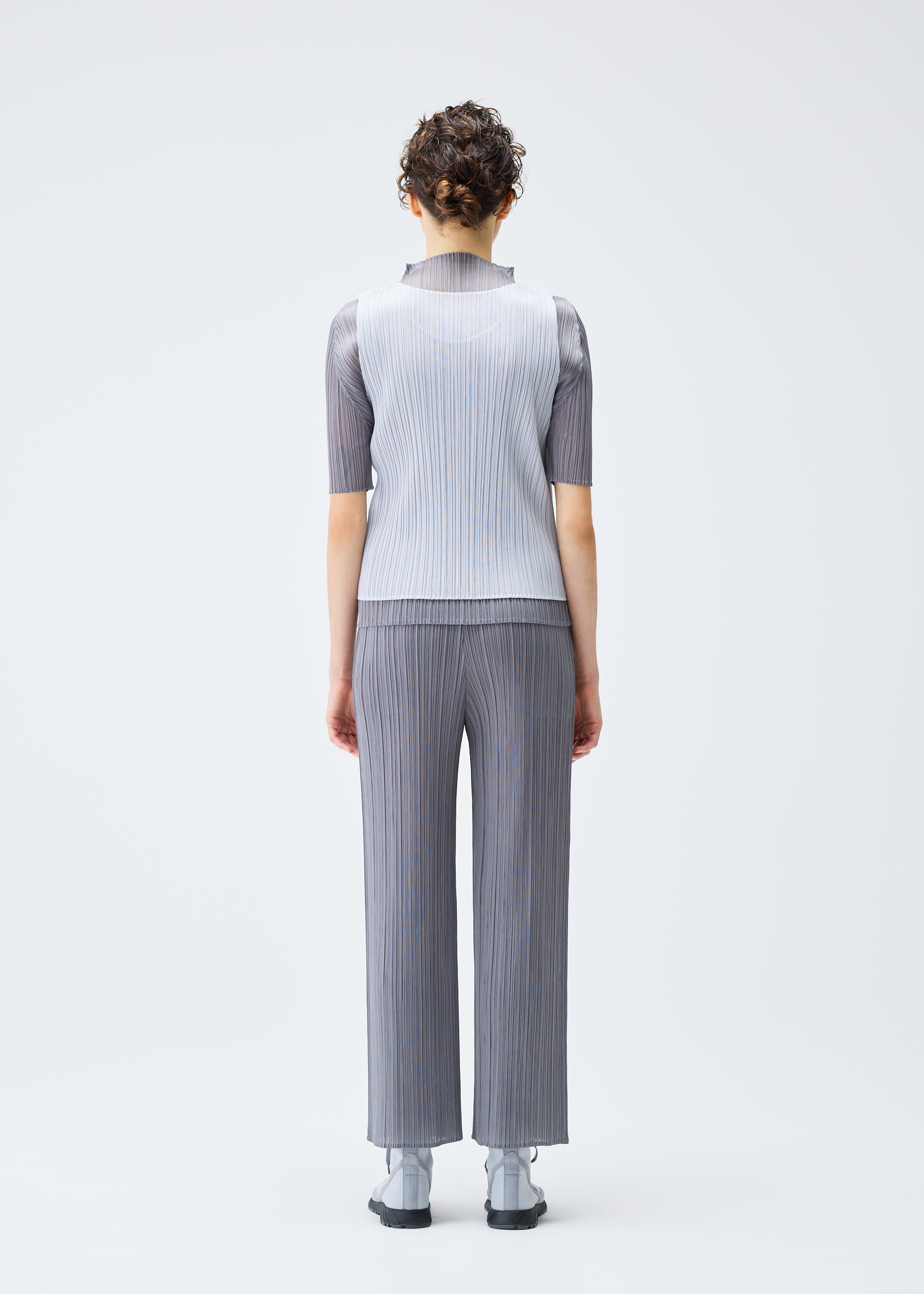 A model wears the PLEATS PLEASE ISSEY MIYAKE LUCID PLEATS top.
