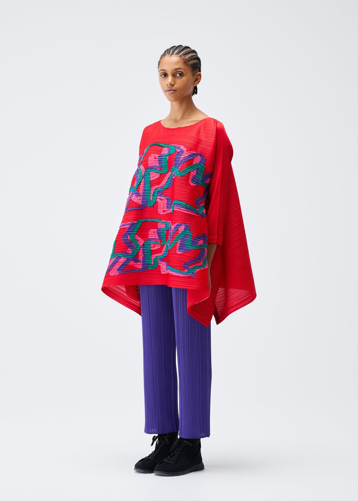 A model wears the PLEATS PLEASE ISSEY MIYAKE MIX top.