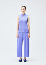 A model wears the PLEATS PLEASE ISSEY MIYAKE MELLOW PLEATS top.