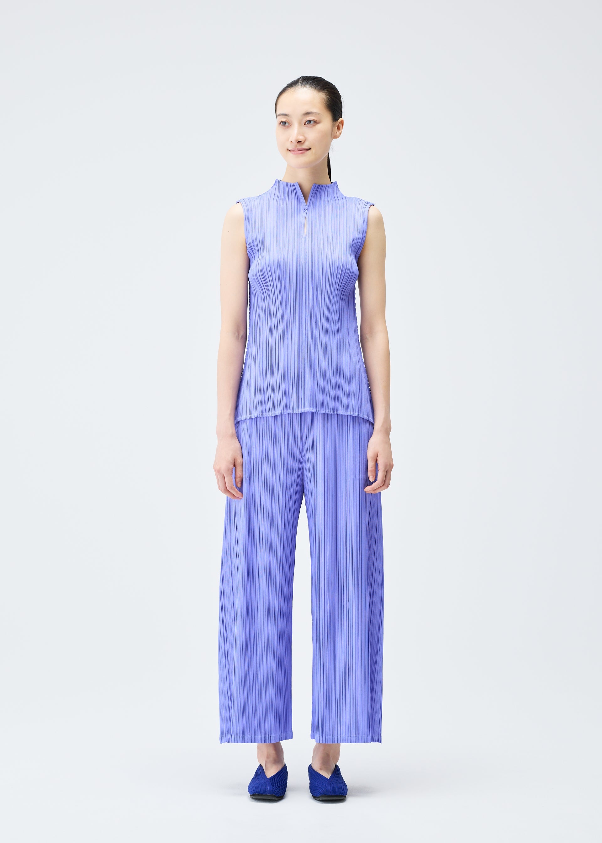A model wears the PLEATS PLEASE ISSEY MIYAKE MELLOW PLEATS top.